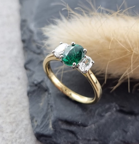 Oval emerald and oval diamond trilogy ring