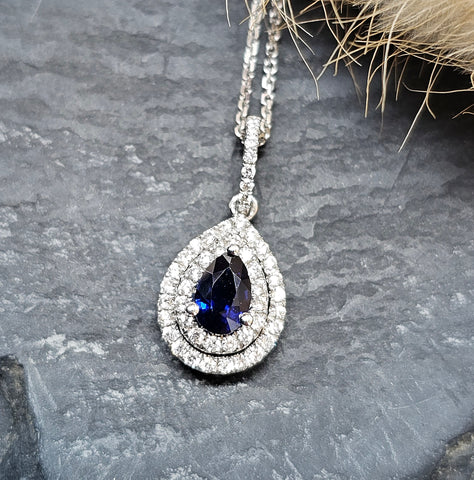 Pear cut sapphire and diamond double halo pendant