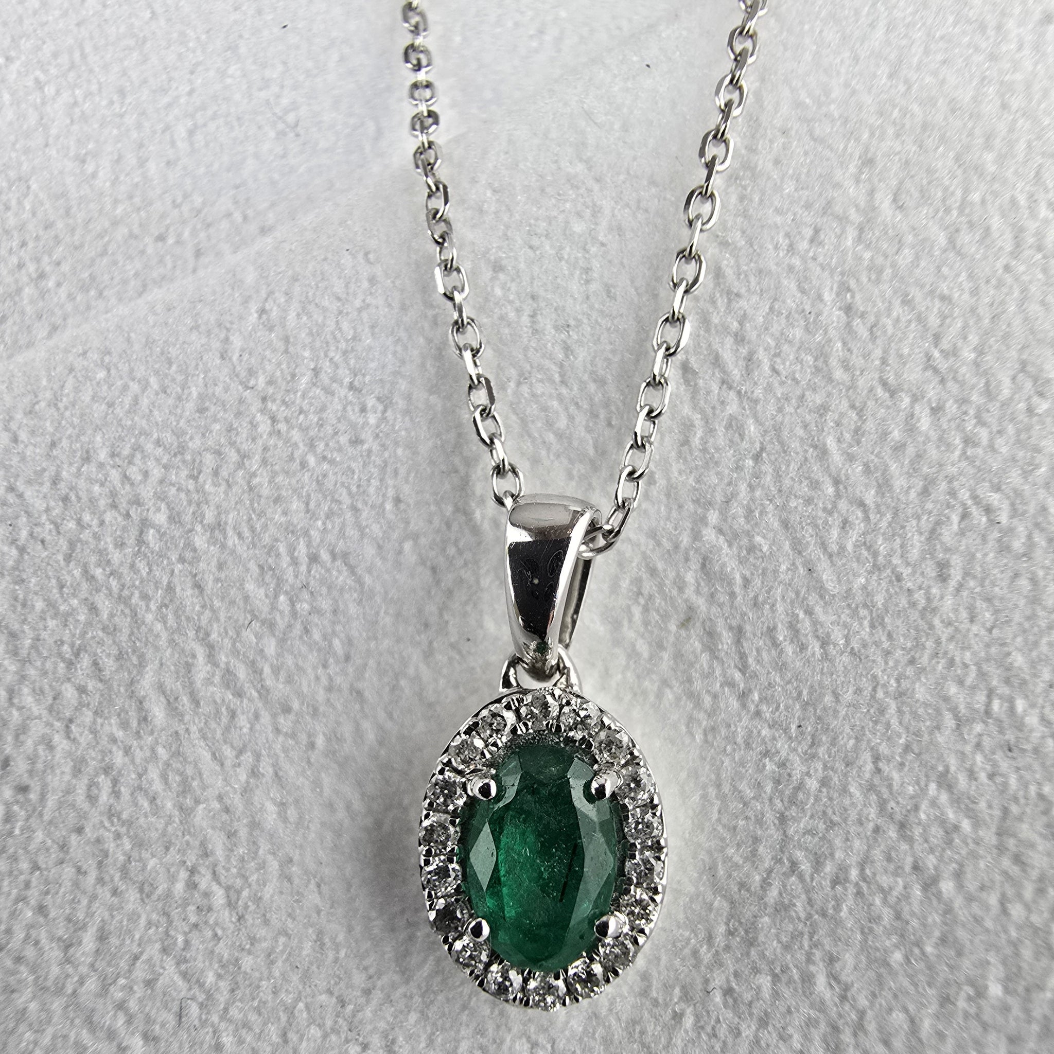 Emerald and diamond oval halo pendant