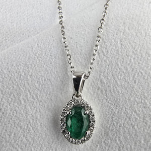 Emerald and diamond oval halo pendant