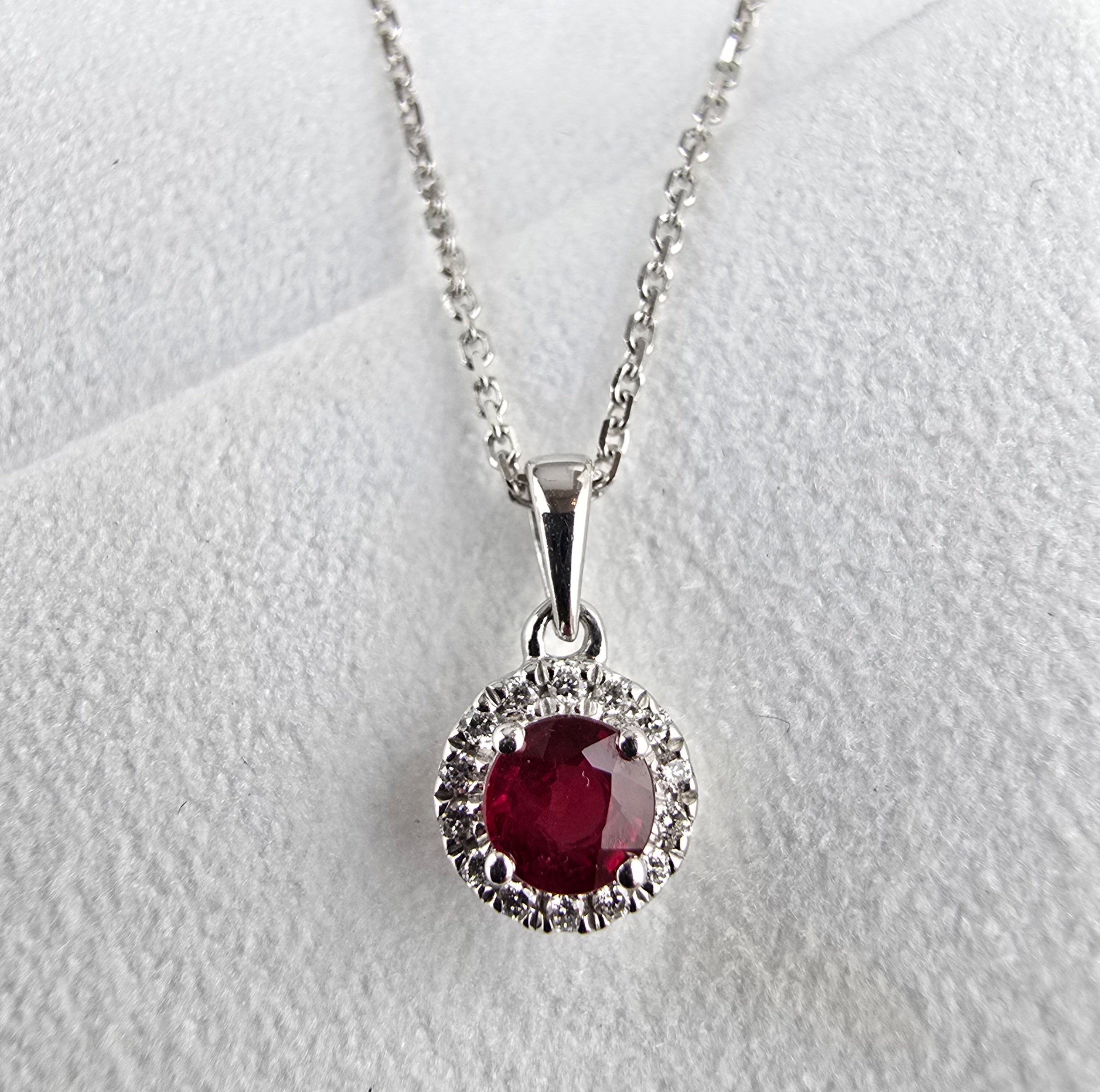 Round ruby and diamond halo pendant