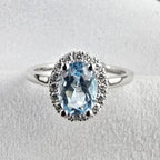 Oval blue topaz halo ring