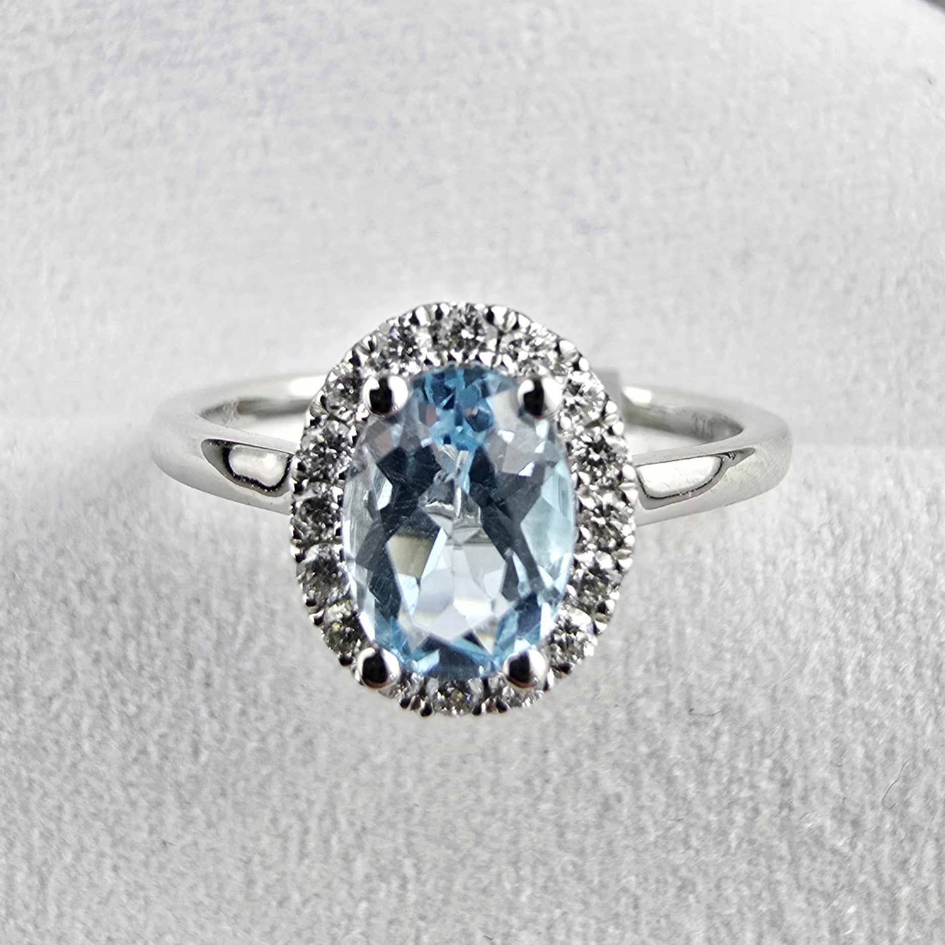 Oval blue topaz halo ring