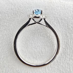 Oval blue topaz halo ring