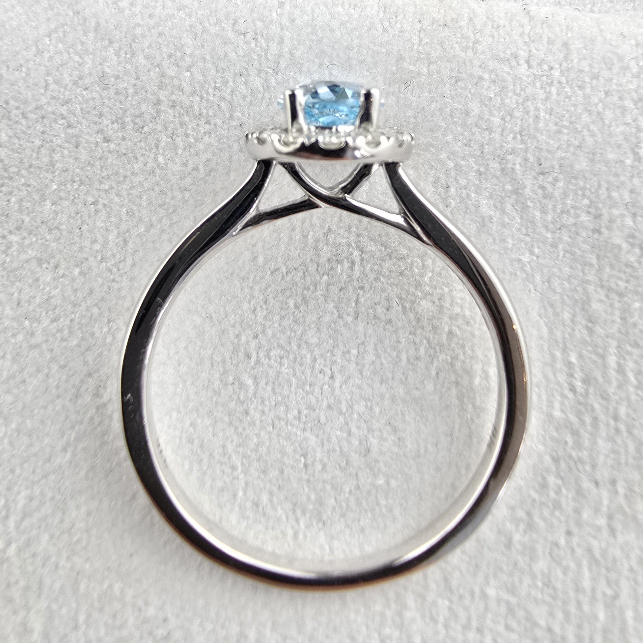 Oval blue topaz halo ring