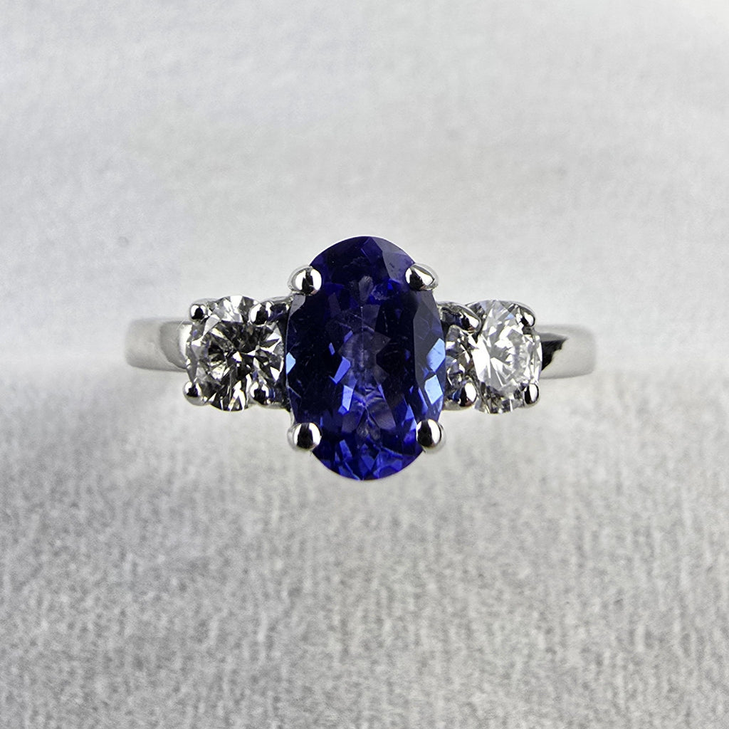 Large oval tanzanite and diamond three stone ring