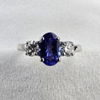 Large oval tanzanite and diamond three stone ring