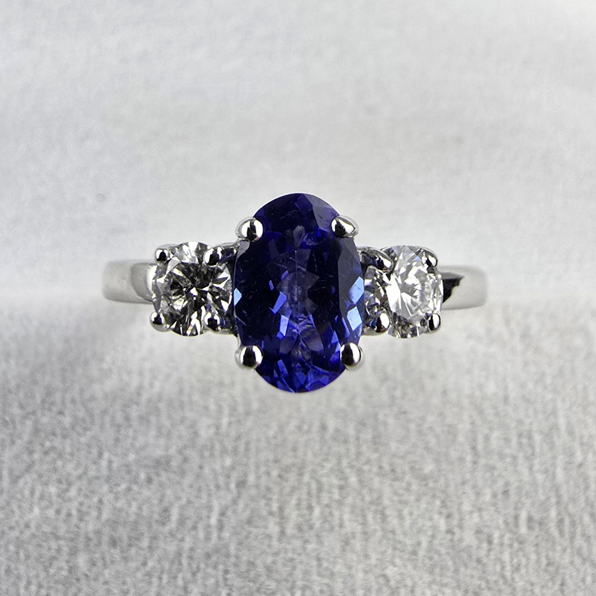 Large oval tanzanite and diamond three stone ring