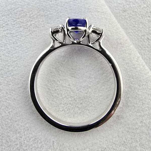 Large oval tanzanite and diamond three stone ring