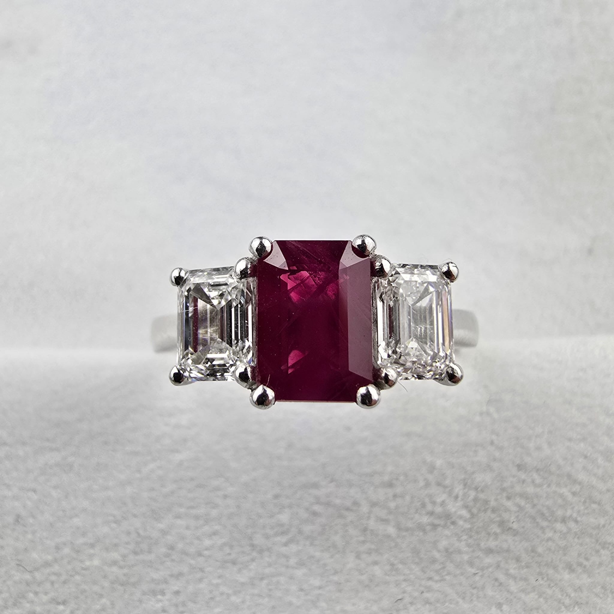 Emerald cut ruby and diamond trilogy ring