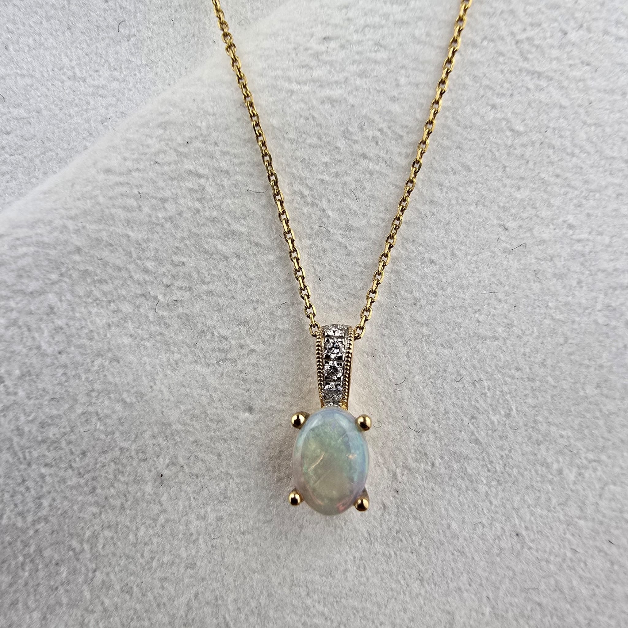 Oval opal and diamond pendant