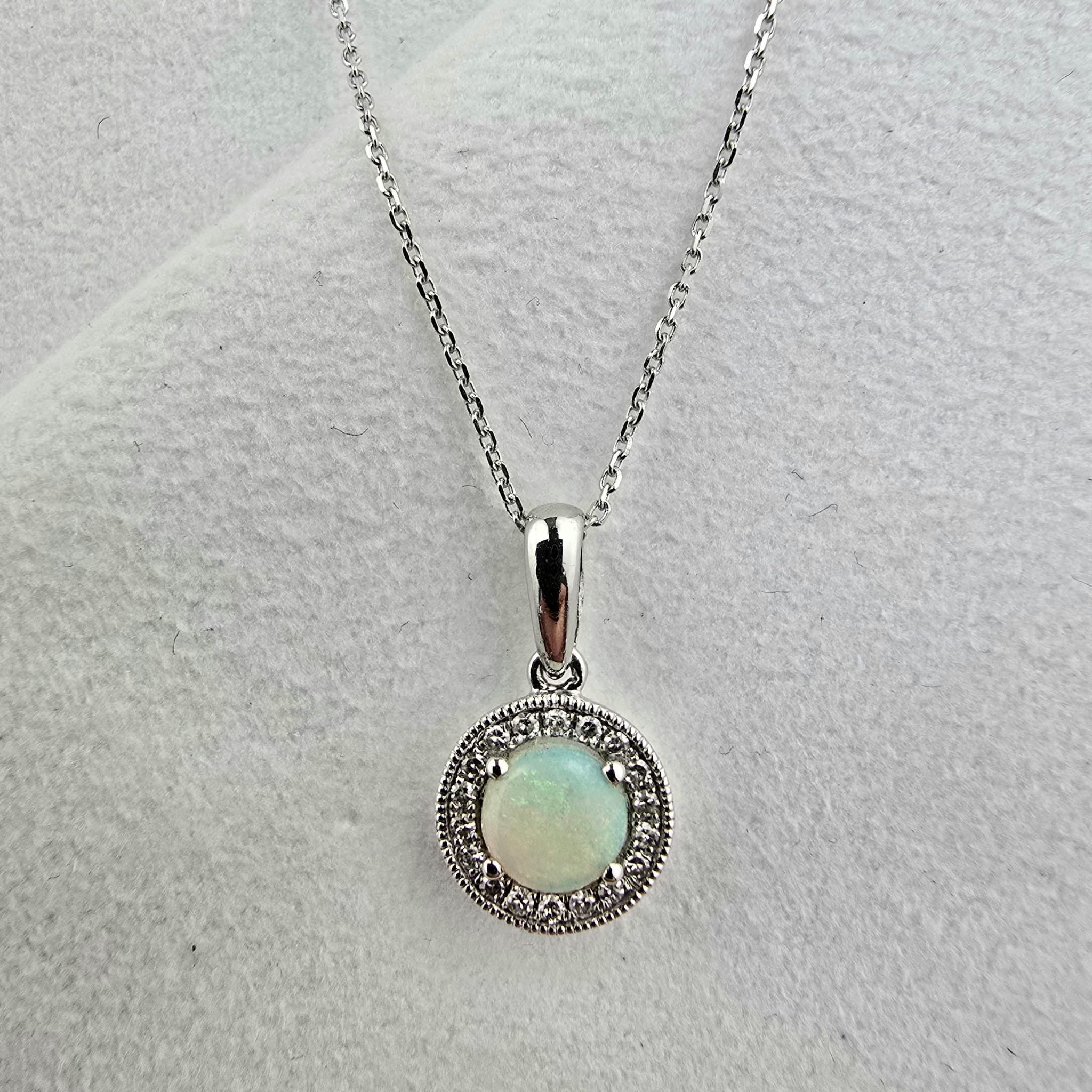Round opal and diamond halo pendant