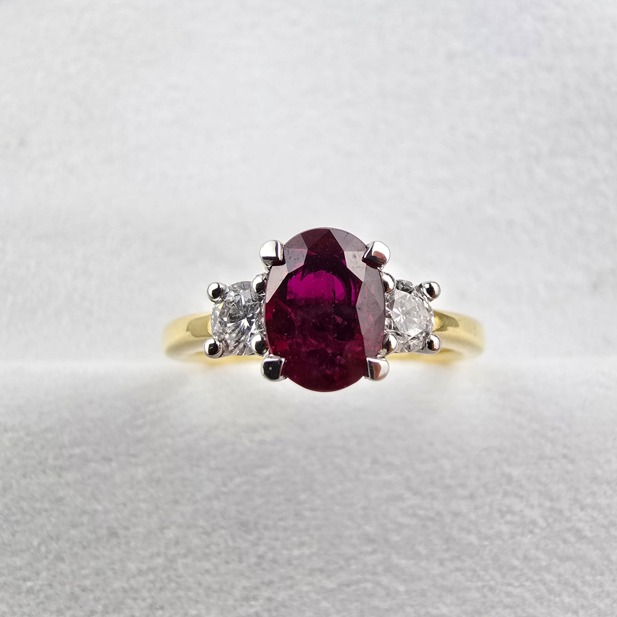 Oval ruby and diamond trilogy ring