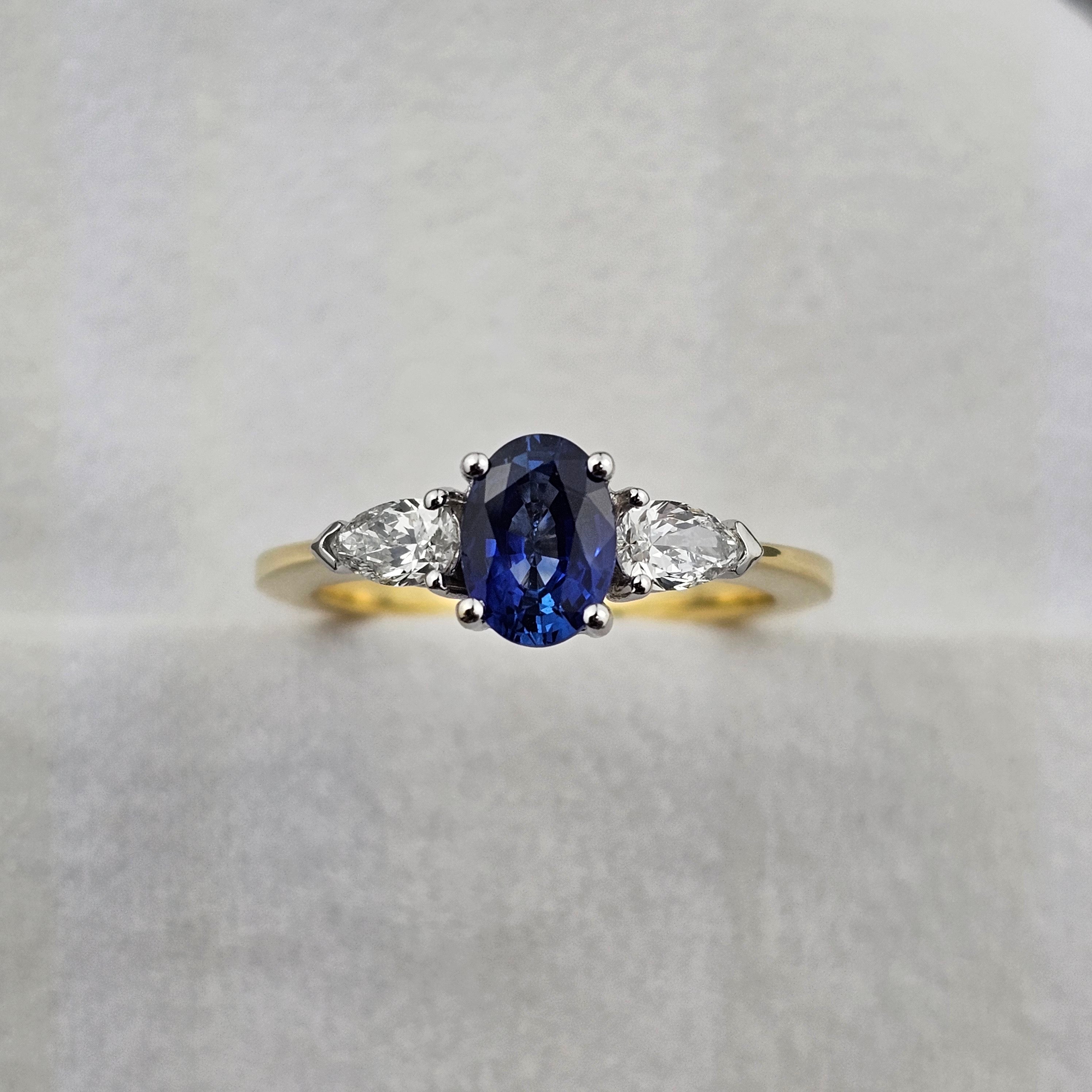 Oval sapphire and pear diamond three stone ring