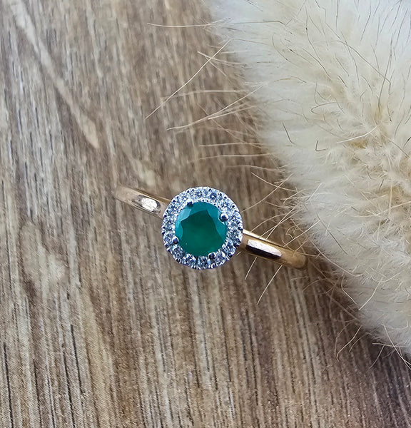 Emerald and diamond halo ring