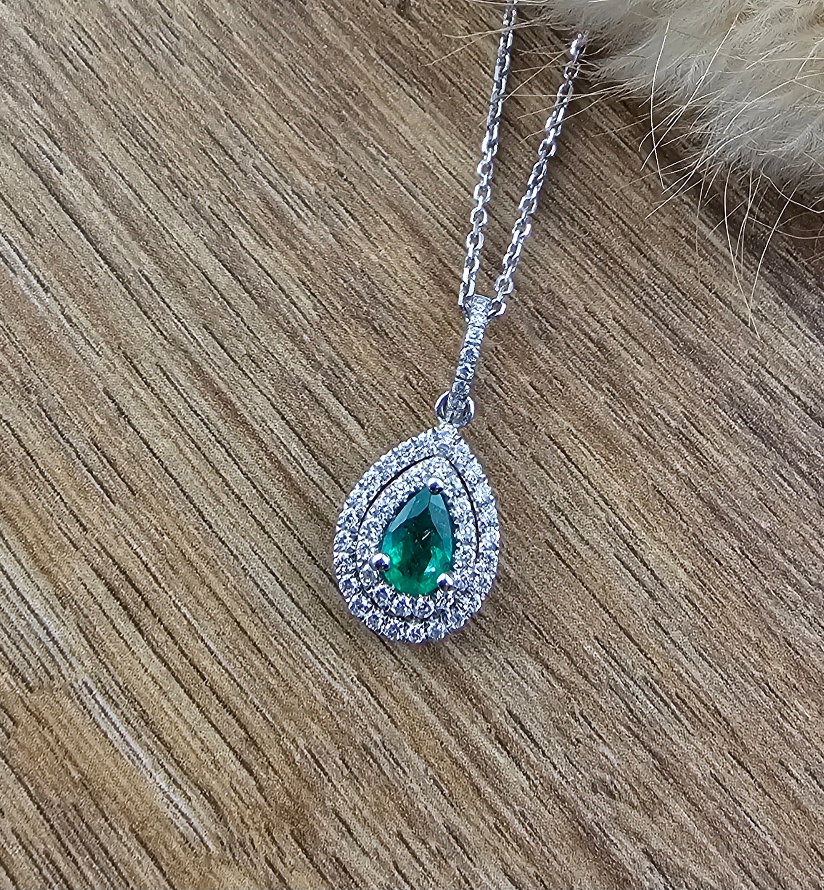 Pear shaped emerald double halo pendant