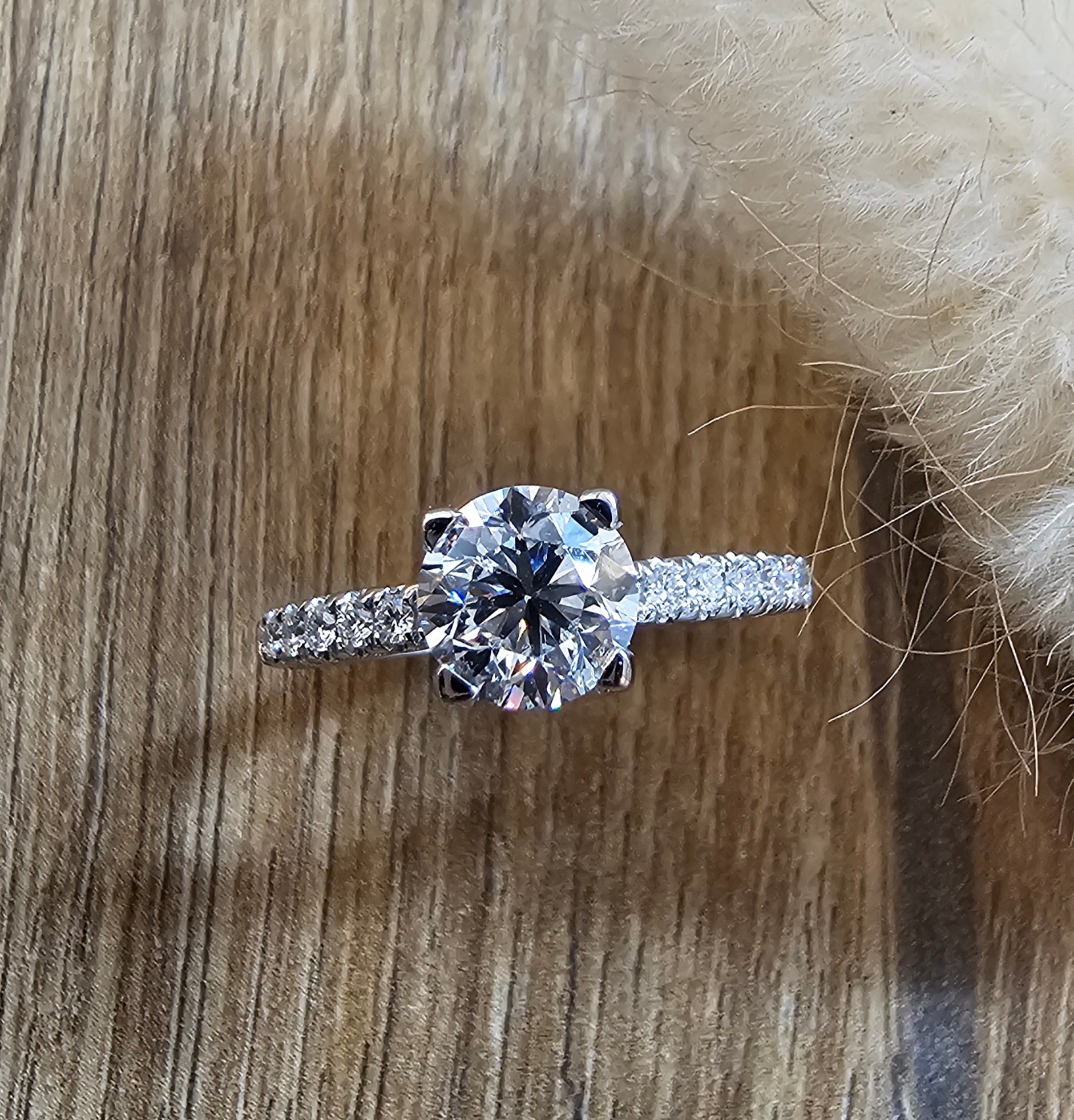 Round diamond solitaire with diamond shoulders
