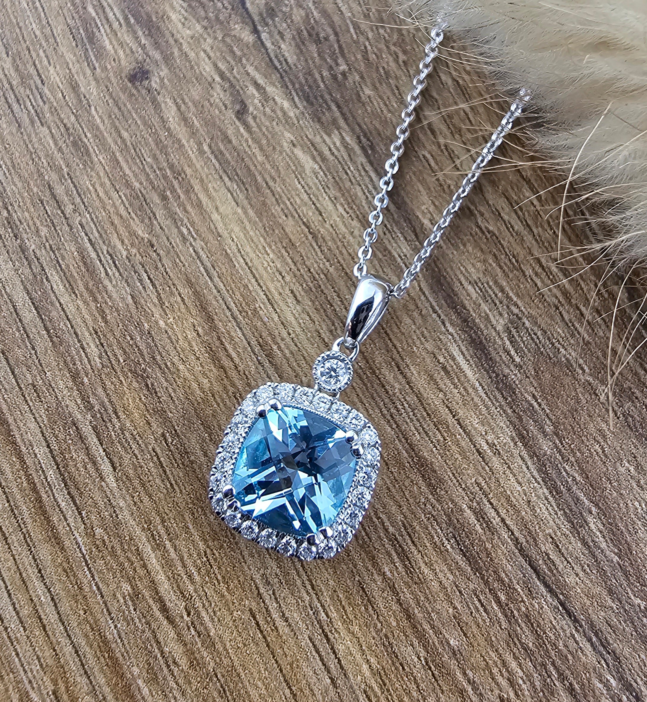 Cushion cut blue topaz halo pendant