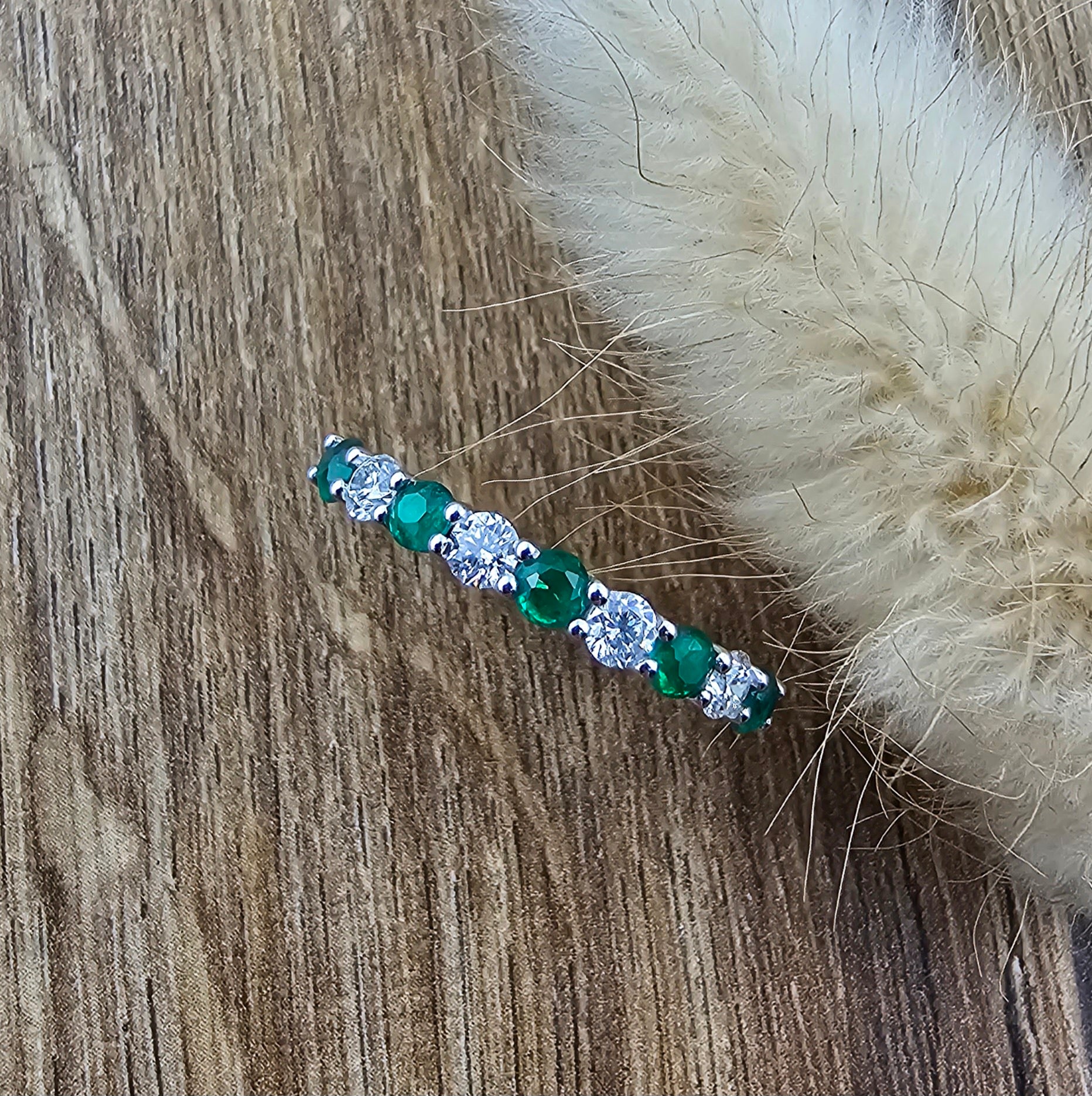 Emerald and diamond claw set eternity ring