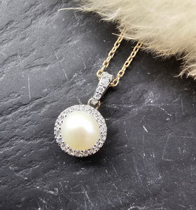 Pearl and diamond halo pendant