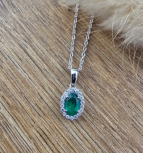 Emerald and diamond oval halo pendant