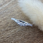 Platinum claw set curved diamond band