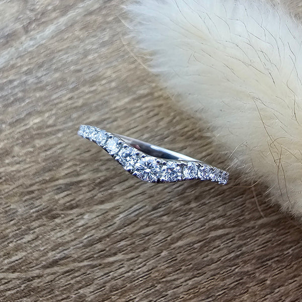 Platinum claw set curved diamond band