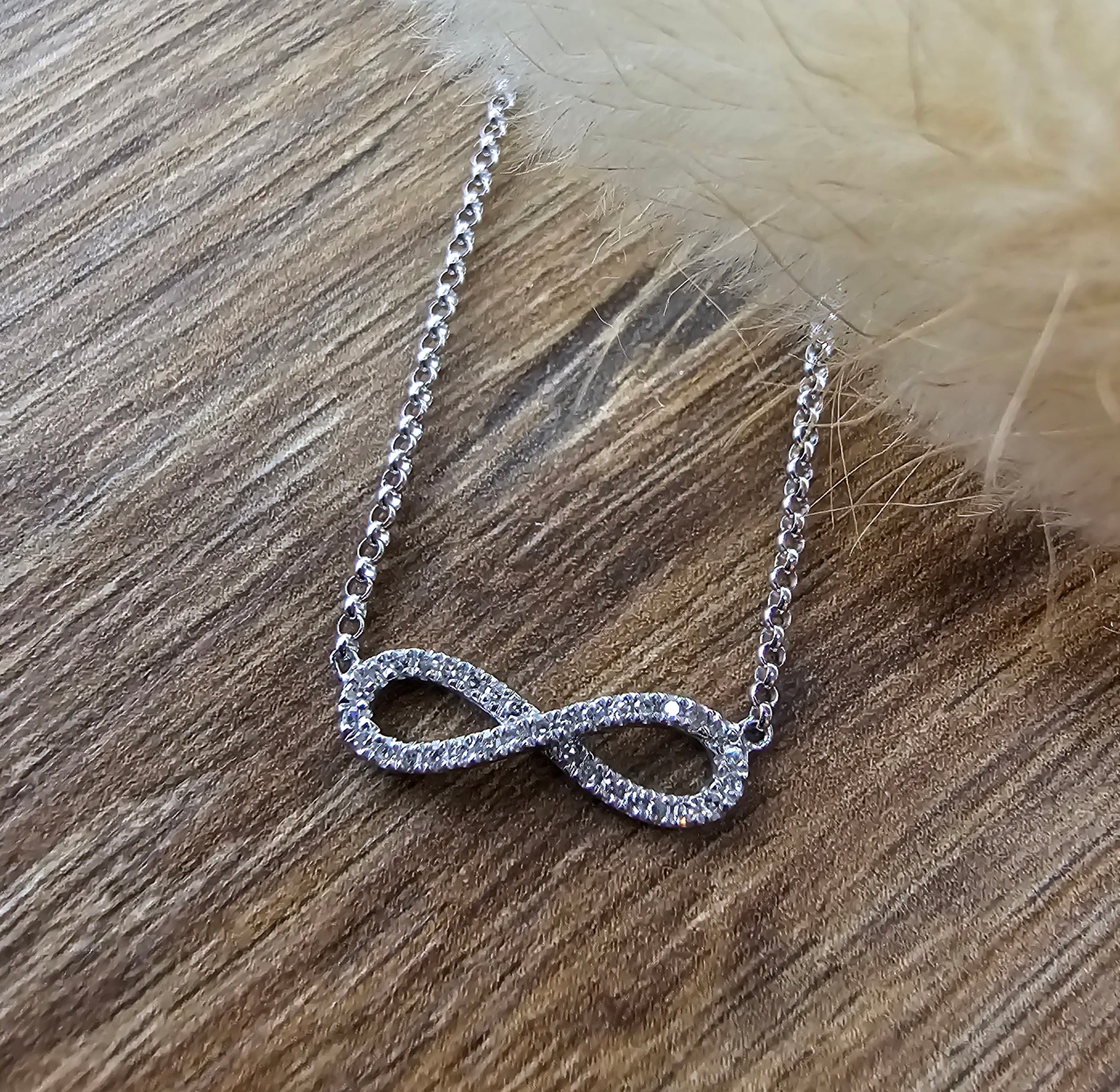 White gold diamond infinity pendant