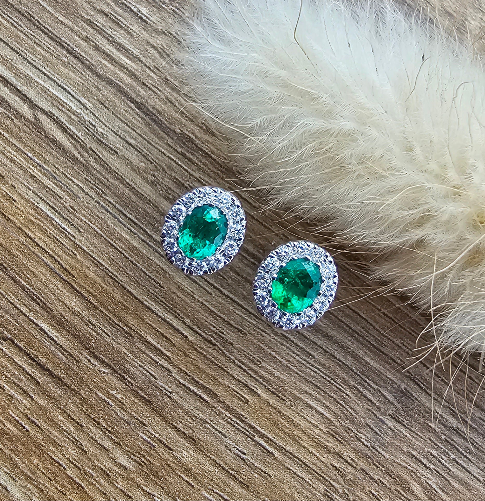 Bright oval emerald halo stud earrings