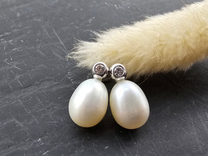 Oval pearl and diamond stud earrings