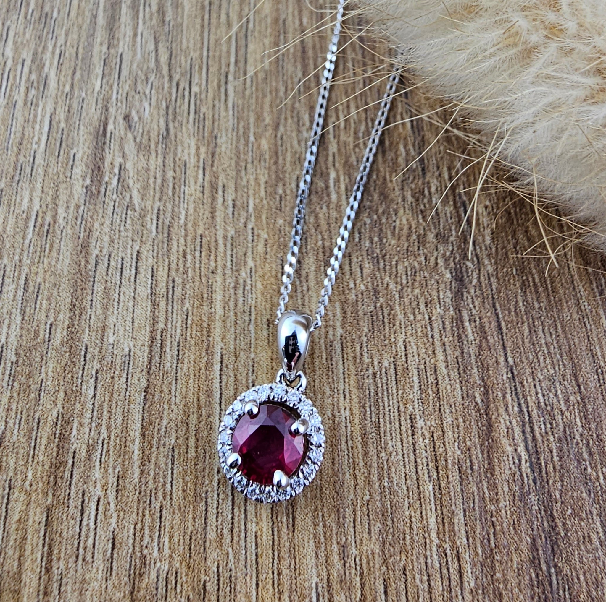 Round ruby and diamond halo pendant