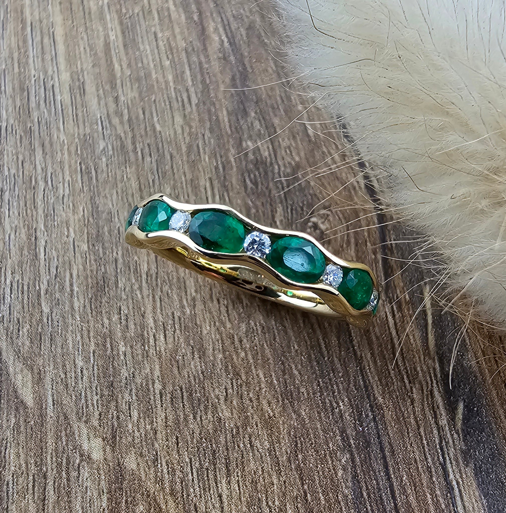 Wave channel set emerald ring