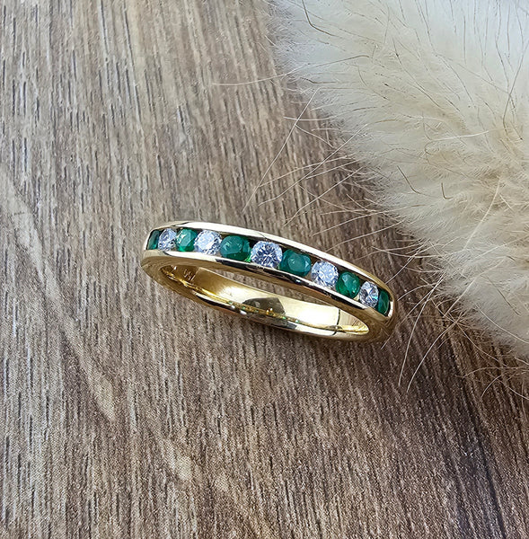 Channel set emerald eternity ring