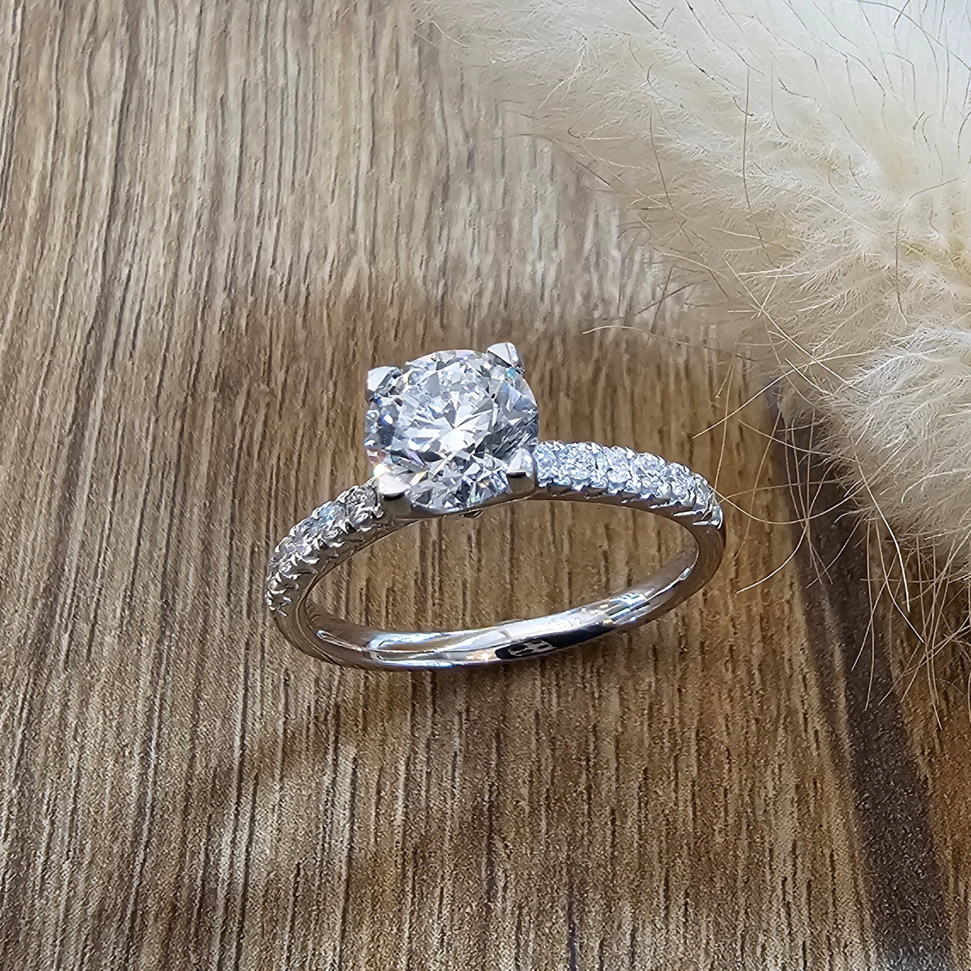 Round diamond solitaire with diamond shoulders