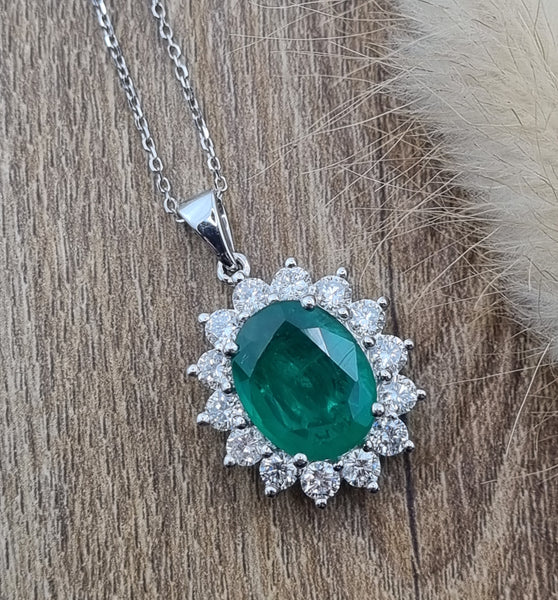 Large oval emerald and diamond cluster pendant