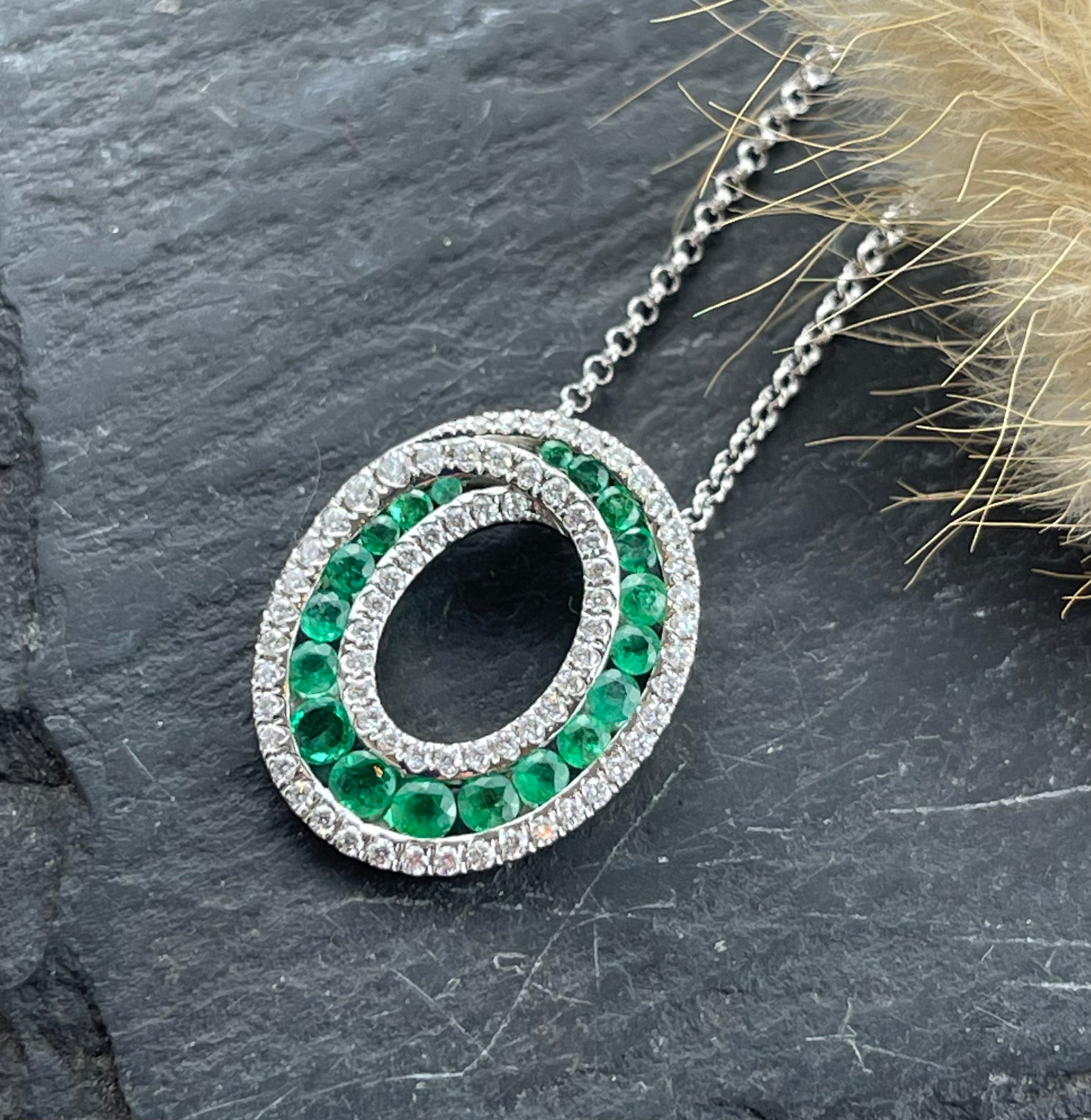 Emerald and diamond oval swirl pendant