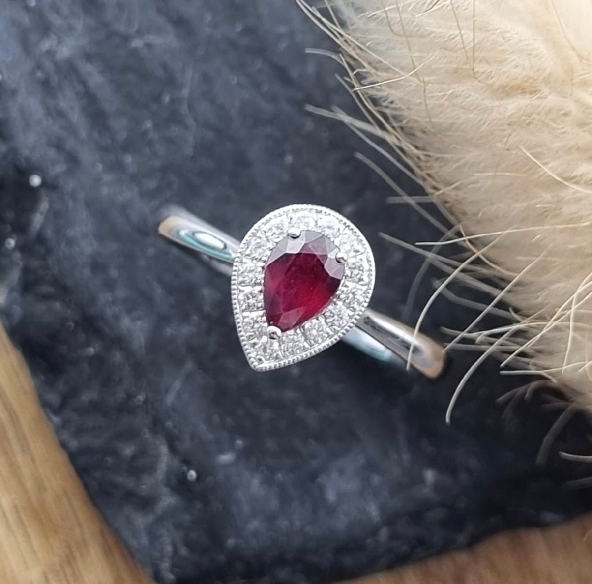 Pear cut ruby halo ring