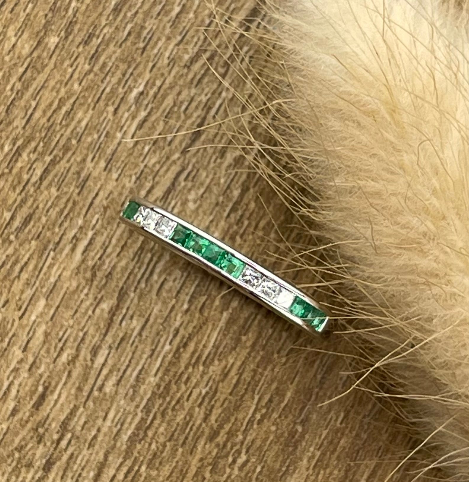 Channel set emerald and diamond band