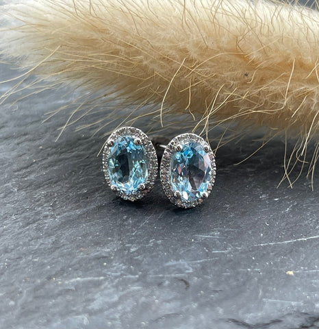 Oval blue topaz halo earrings