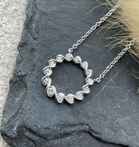 Diamond ribbon circle pendant