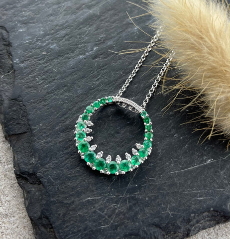 Circular emerald and diamond pendant