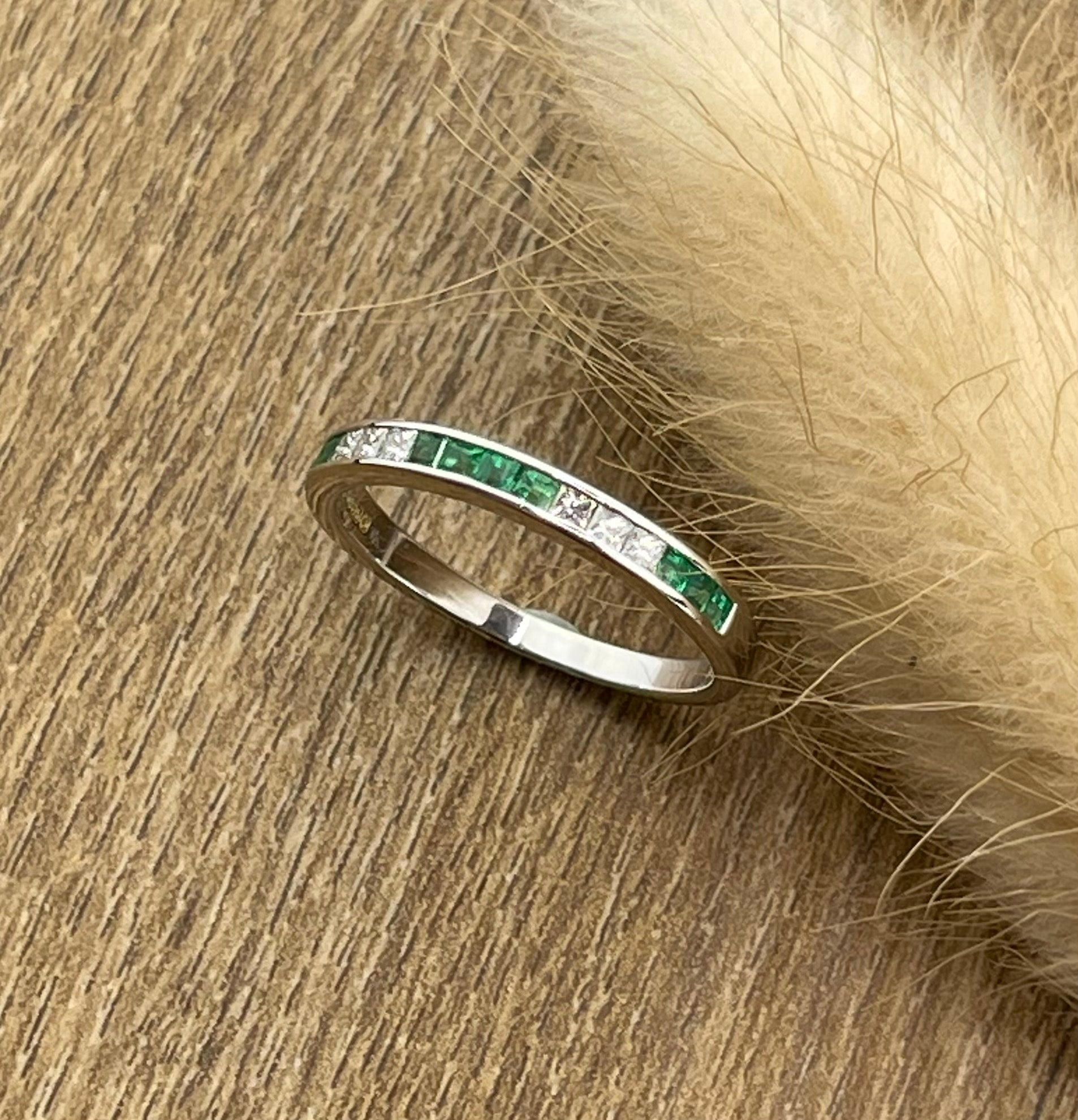 Channel set emerald and diamond band