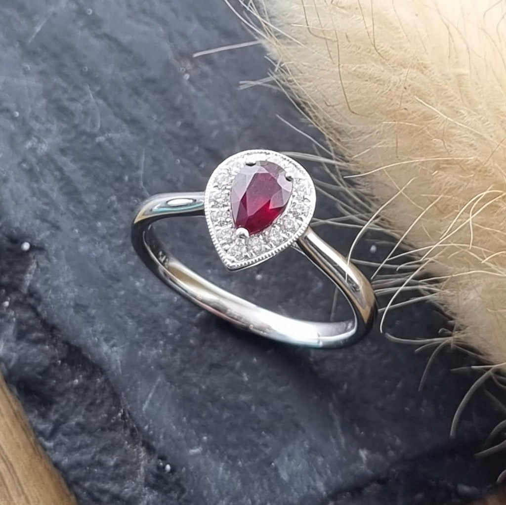 Pear cut ruby halo ring