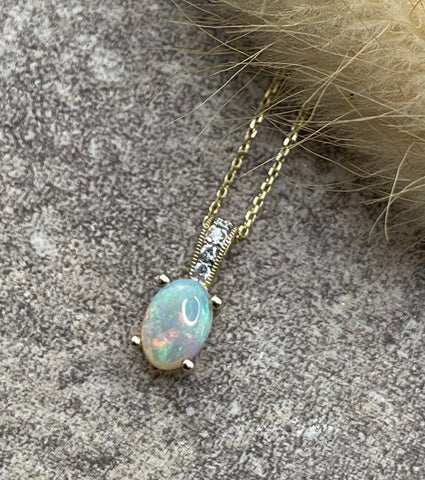 Oval opal and diamond pendant